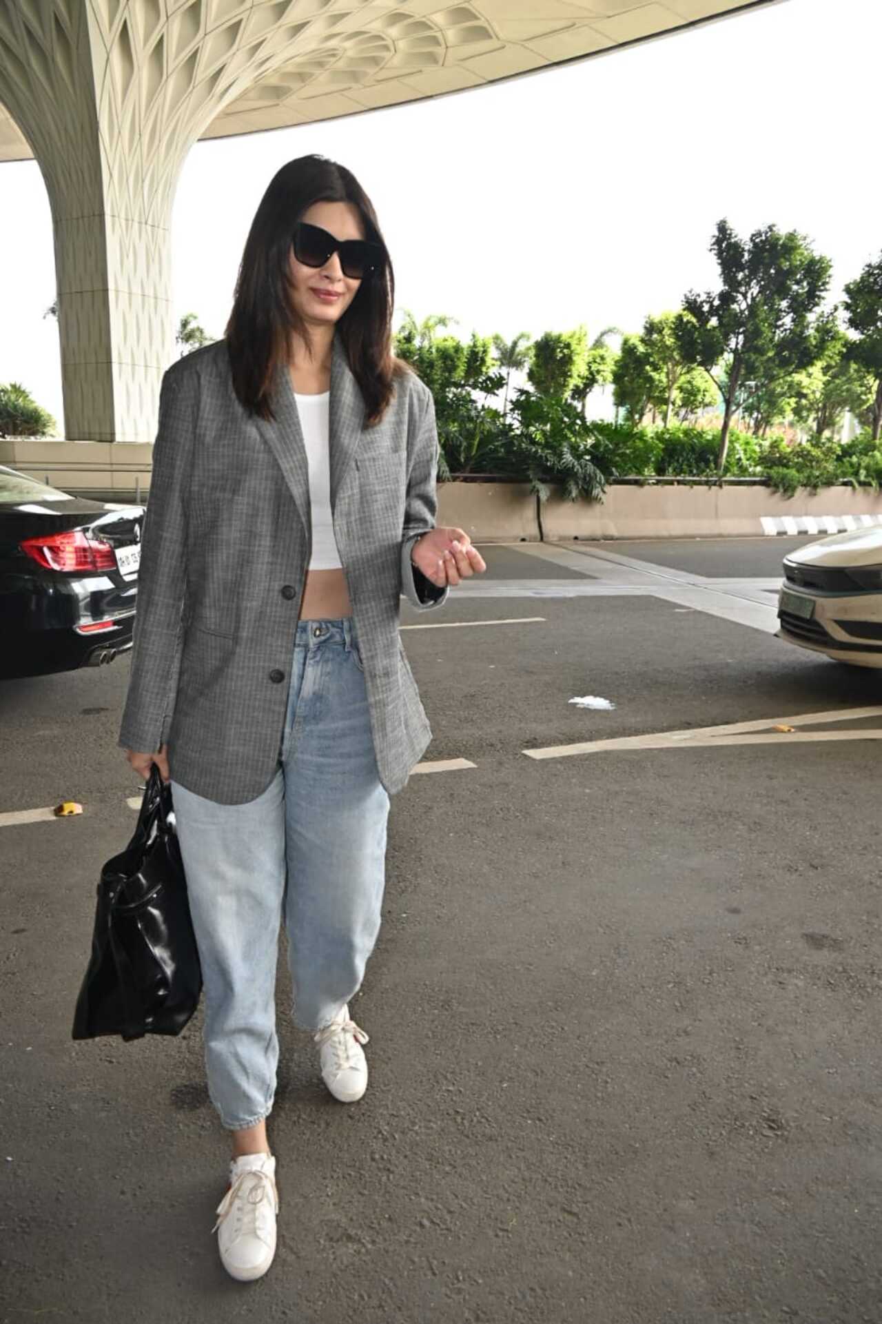 Diana Penty was at the airport. The actress wore a white crop top and paired it with a checkered jacket and baggy pants